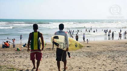 SURFING TIME. Two members of the Bagasbas Unified Surfers Association prepare for their surfing class. Photo by Izah Morales.