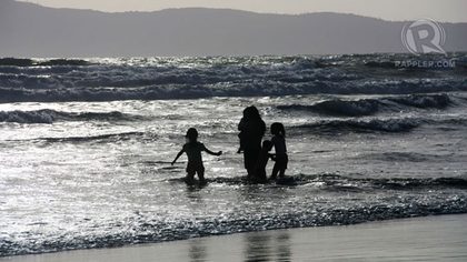 BONDING MOMENTS. A family enjoys the waves of Bagasbas beach together. Photo by Izah Morales.