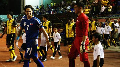 GOOD SPIRITS. James Younhusband shares a smile with Neil Etheridge as they walk to the pitch before the game. February 29, 2012. Emil Sarmiento.