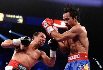 DECISION. Manny Pacquiao slugs it out with Juan Miguel Marquez for the WBO Welter Weight Title at the MGM Grand Garden Arena Nov 12, 2011 in Las Vegas. AFP photo