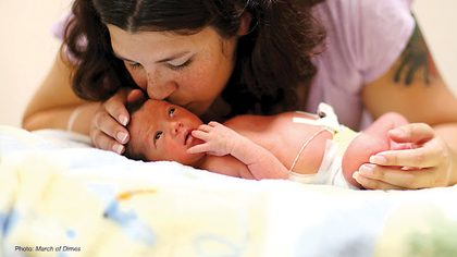 MOMMY CARES. Susan Bryant kisses her son Xander, born 6 weeks early, in the NICU at the University of Arkansas for Medical Sciences (UAMS).