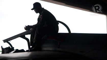 PILOT. An air force pilot takes a breather on top of his fighter jet. Visitors are allowed to have photos taken while sitting in the cockpit of some jets.